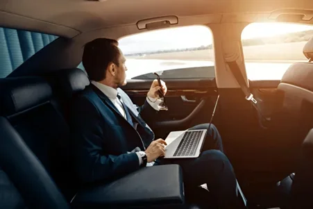 Man with Laptop in Car, Corporate Transportation nyc, RNR