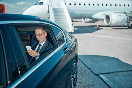 Happy Man Using Mobile in Executive Black Car, RNR Transportation